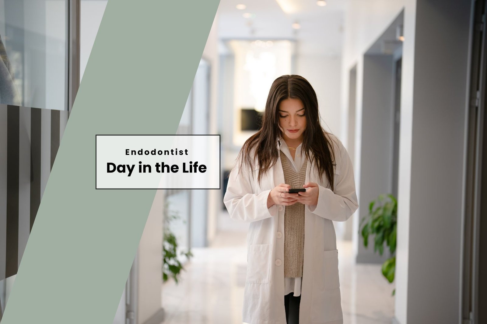 female endodontist walking down hallway in hospital clinic looking at iphone